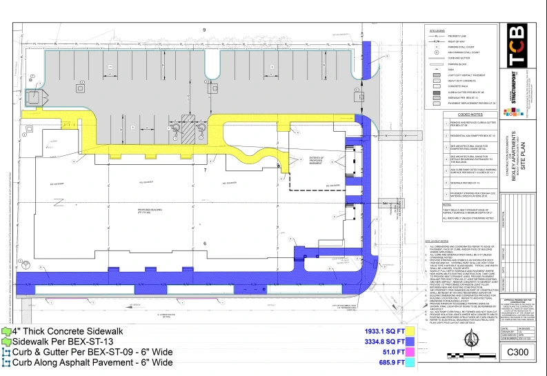 Ground floor architectural plan showing interior room layout, exterior concrete sidewalks, curb and gutter installations, and asphalt pavement areas with detailed specifications and measurements