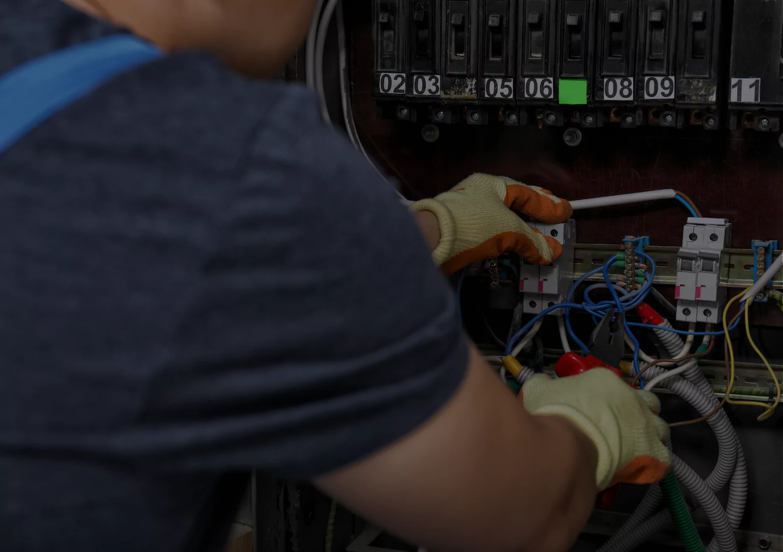 Electrician installing electrical panel wiring for construction project cost estimation and electrical systems planning