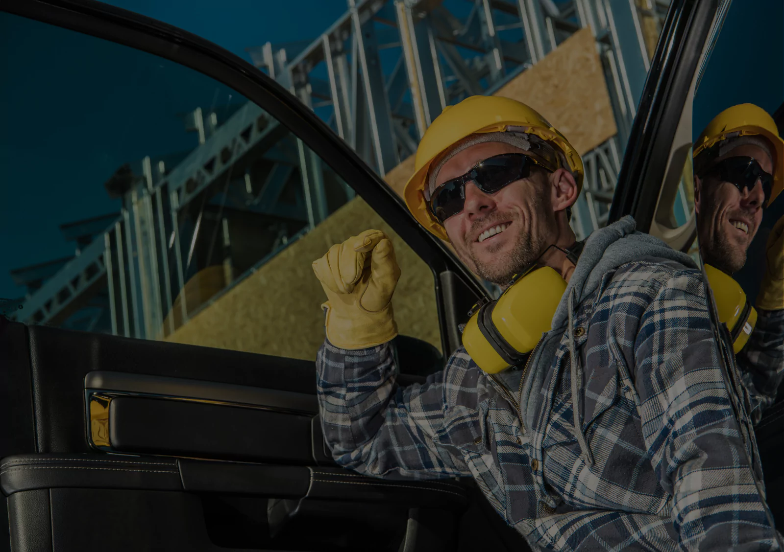 Construction workers in hard hats and safety gear operating heavy machinery at job site for accurate project estimating